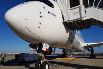 a white airplane with a door open