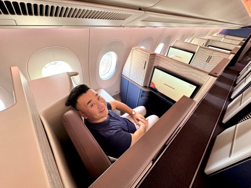 a man sitting in a chair in an airplane