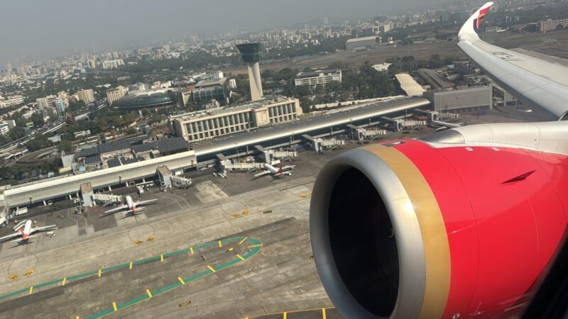 an airplane wing and a city