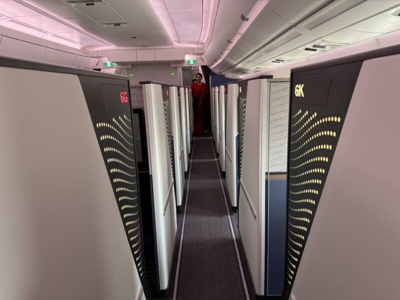 a person standing in a hallway with lockers