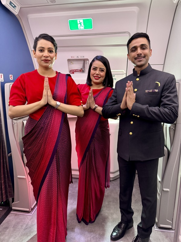 a group of people standing in a room with their hands together