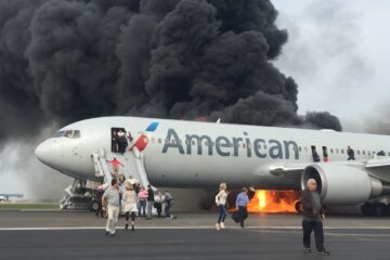 a plane with people walking on the ground