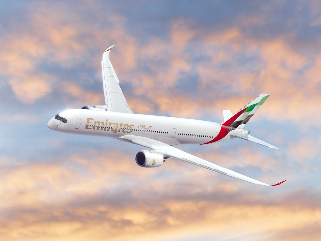 a white airplane flying in the sky