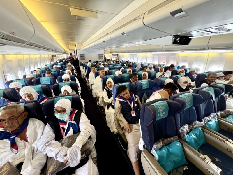 a group of people sitting on an airplane