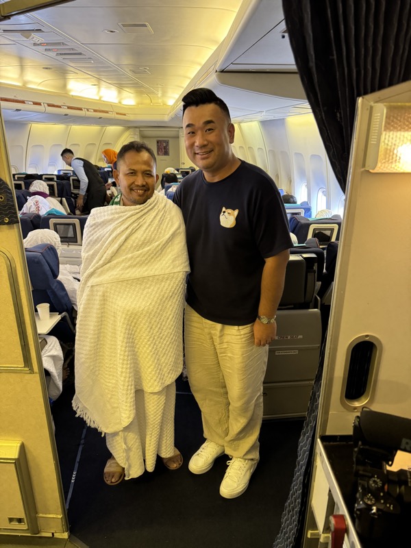 two men standing in an airplane