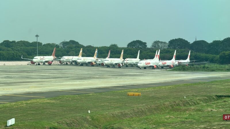 a group of airplanes parked on a runway