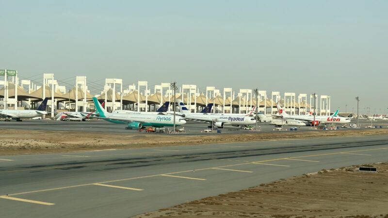 a group of airplanes on a runway