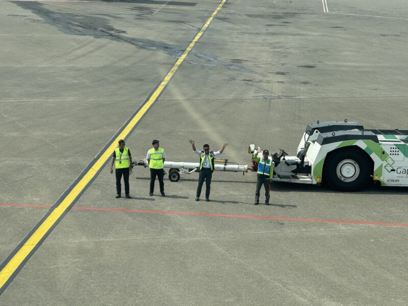 a group of men standing next to a large vehicle