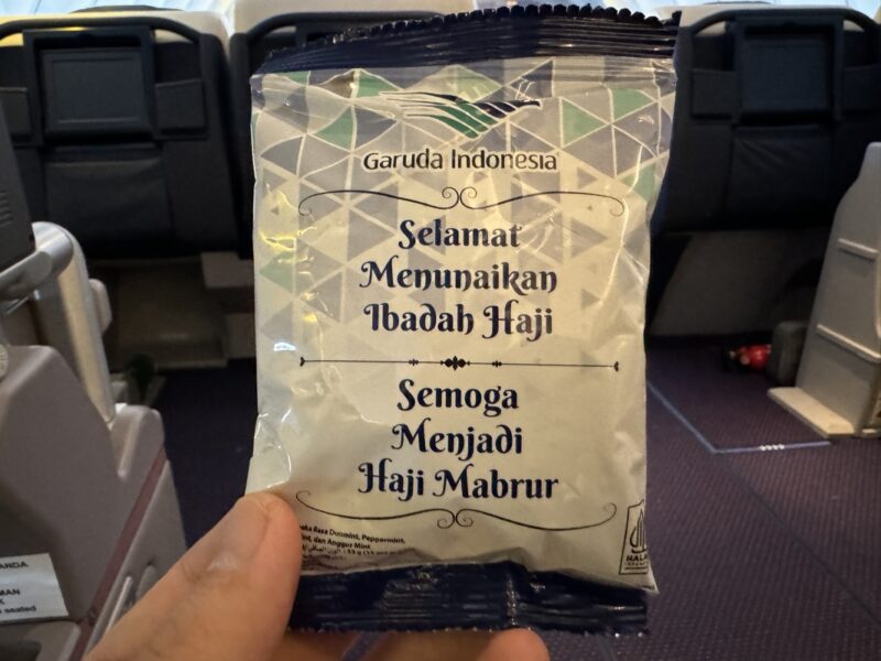 a hand holding a small packet