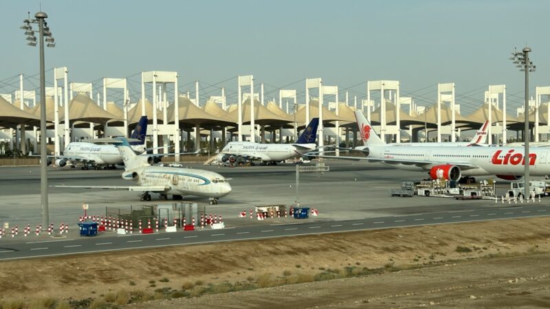 a group of airplanes on a runway
