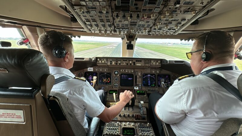 two men in the cockpit of an airplane