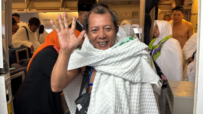 a man waving in a white towel