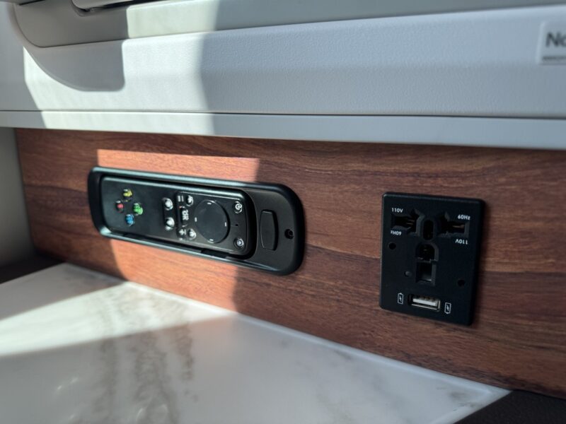 a black electrical outlet and plugs on a wood surface