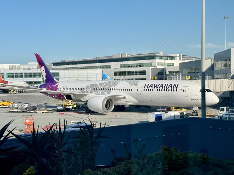 a large white airplane parked in a terminal