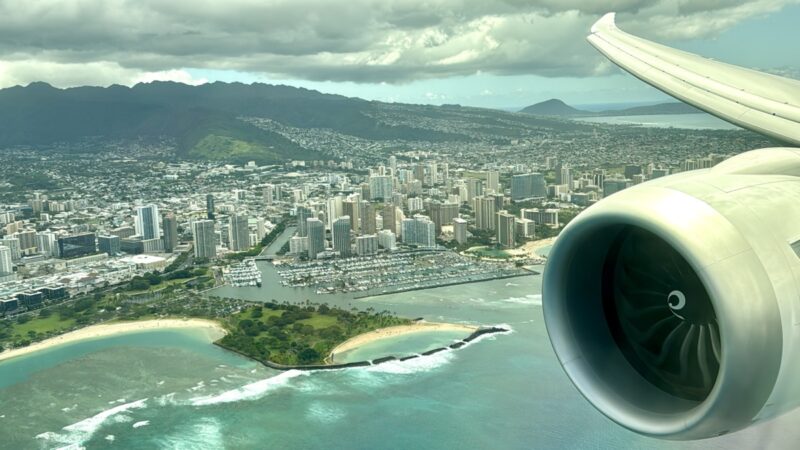 an airplane wing and a city