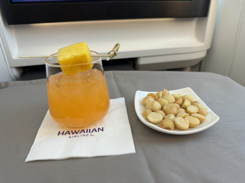 a plate of nuts and a drink on a table