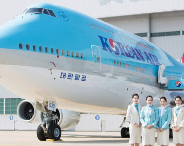 a group of women standing in front of a large airplane