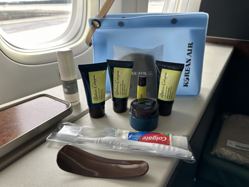 The amenity kit is not branded, a plastic blue bag with the usual amenities. There are also pajamas.