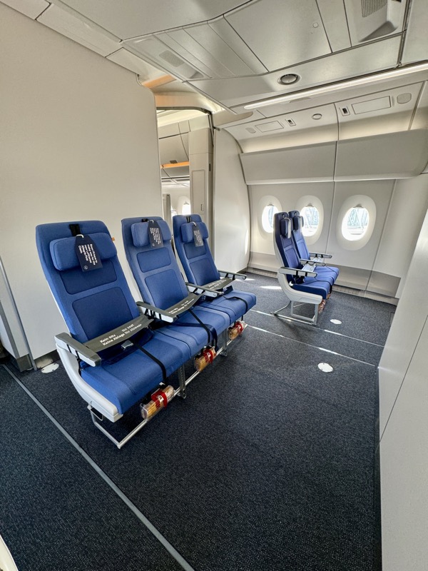 a row of blue seats in an airplane