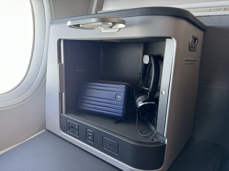 a small box with a suitcase and headphones inside