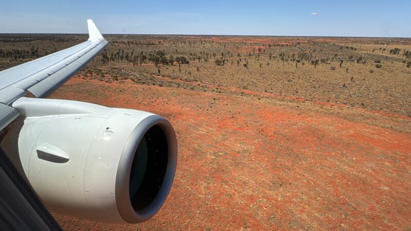 an airplane wing and a landscape