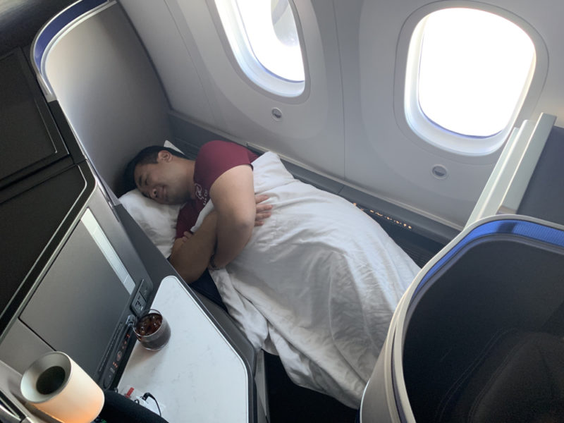 a man sleeping on an airplane