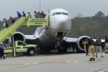 a group of people standing next to a plane