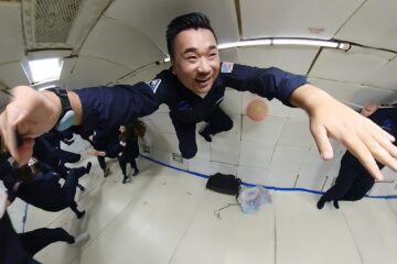 a man in uniform jumping in a room